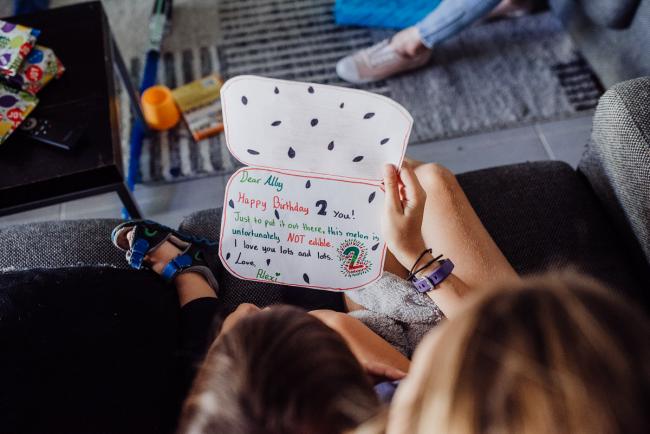 20190412-DSC_1624 Top down image of kids reading a handmade birthday card with Perth lifestyle family photographer