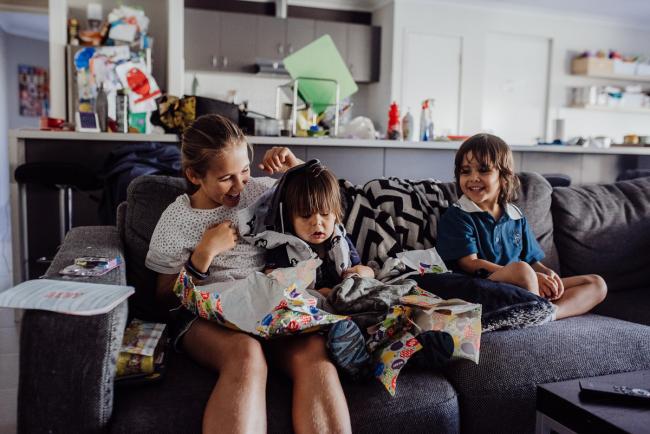 20190412-DSC_1650 Brother and sister watching as their little brother opens birthday presents on the couch with Perth lifestyle family photographer