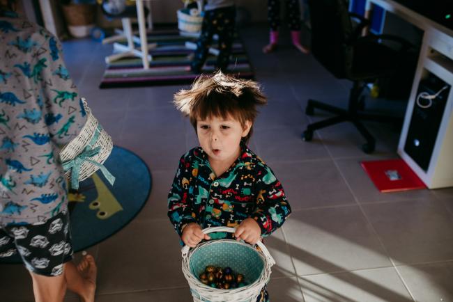 20190421-DSC_2007 Little boy with a surprised face as he carries his easter egg basket with family photographer Perth