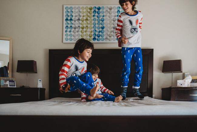20190422-DSC_2308 Boys jumping on the bed with one boy in mid flight with family photographer Perth