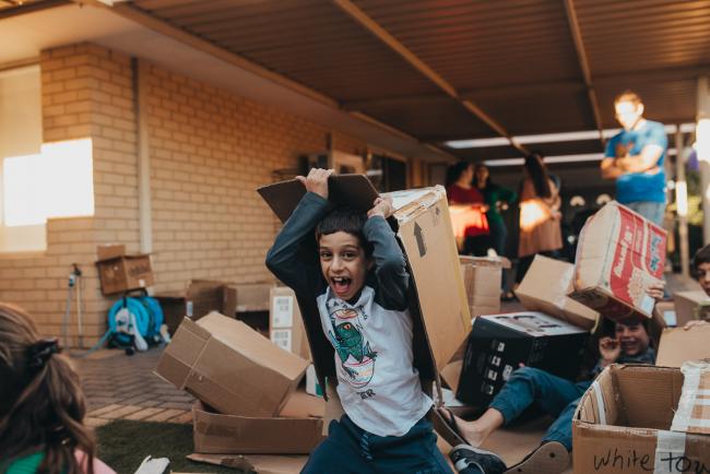 20190422-DSC_2802 Boy laughing as he lifts a box off of his head with Perth family photographer