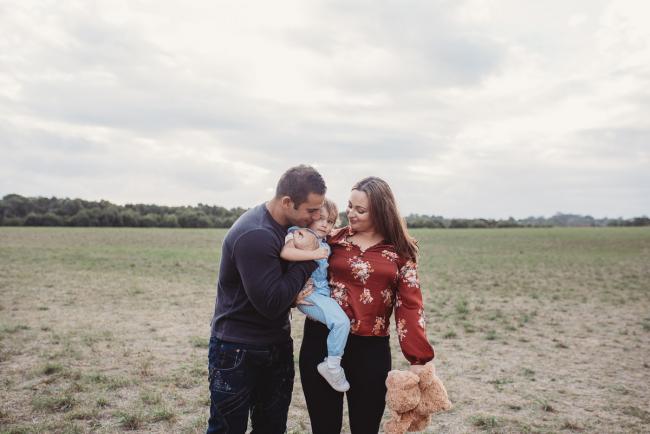 Family of 3 standing in a field with Perth family photographer at Perry's Paddock