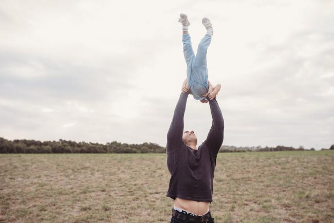 Father flying his daughter in the air with Perth family photographer at Perry's Paddock