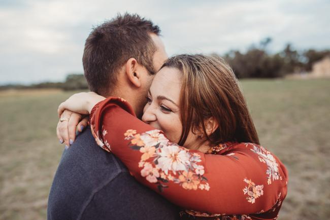 Woman laughing as she hugs her husband with Perth family photographer at Perry's Paddock