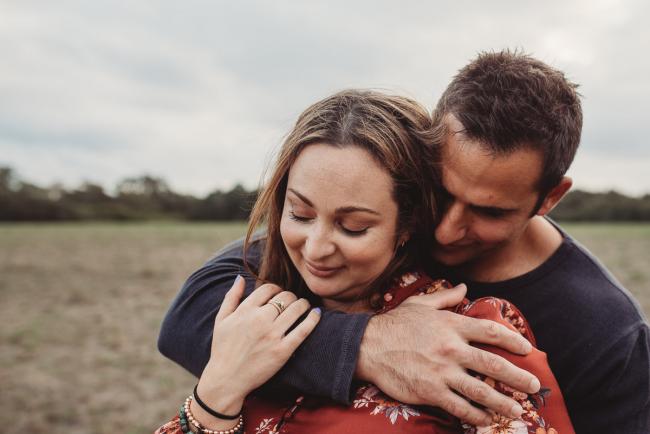husband embracing his wife with Perth family photographer at Perry's Paddock