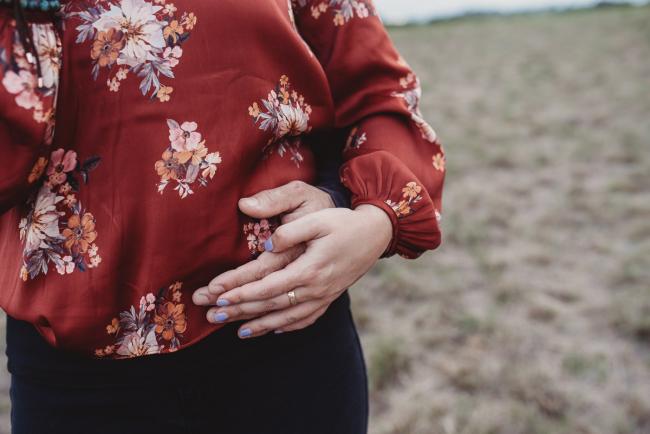 Husband and wife's hands on her waist with Perth family photographer at Perry's Paddock