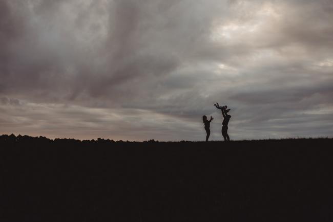 Silhouette of family in a field with Perth family photographer at Perry's Paddock