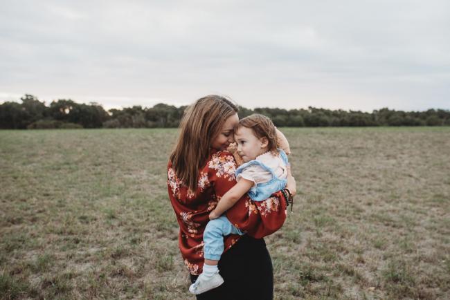 Mother holding her daughter with Perth family photographer at Perry's Paddock