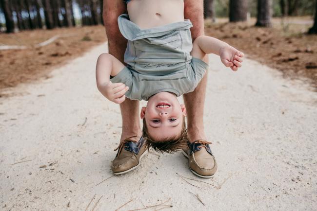 Family-Photographer-Perth-The-Pines-19-of-21 Little boy upside down during a Family photographer session at The Pines in Wanneroo