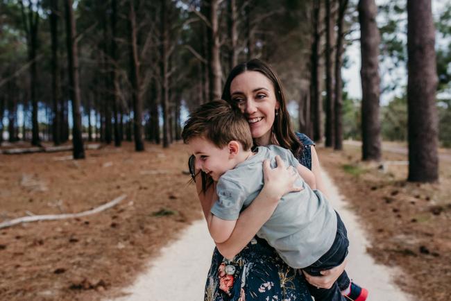 Family-Photographer-Perth-The-Pines-21-of-21 Mother and son laughing as she holds him during a Family photographer session at The Pines in Wanneroo