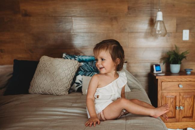 Little girl sitting on the bed with Perth lifestyle family photographer
