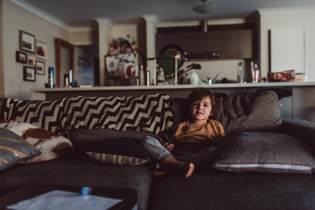 Little boy sitting on the couch with Perth lifestyle photographer