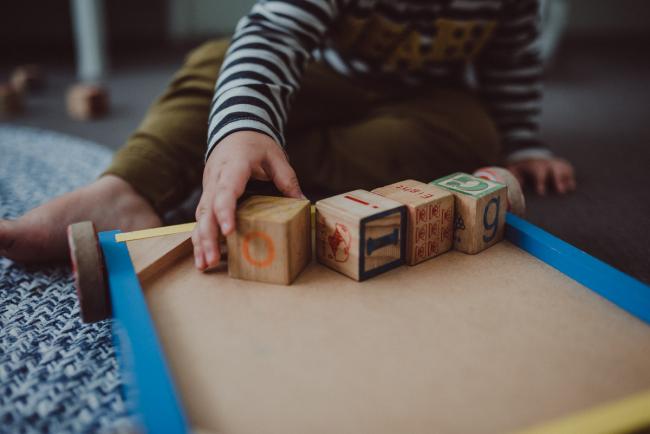 Close up of little boys hand on a block with Perth family photographer