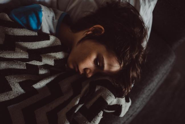 Close up of boy sleeping on the couch with Perth family lifestyle photographer