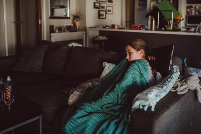 Girl sitting on the couch with a blanket with Perth family lifestyle photographer