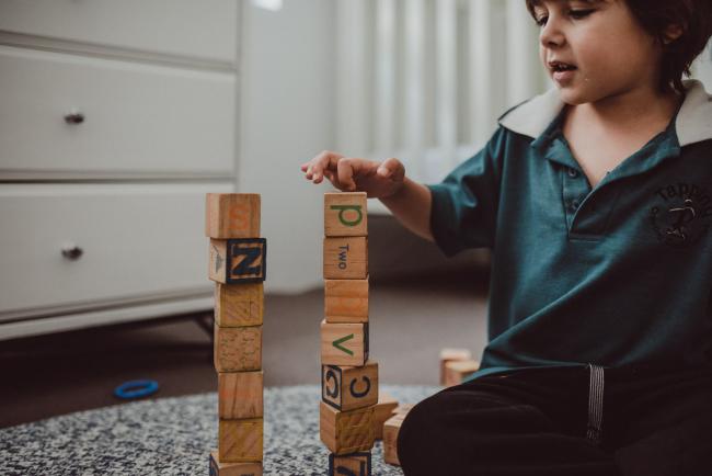 Little boy building a block tower with Perth family photographer