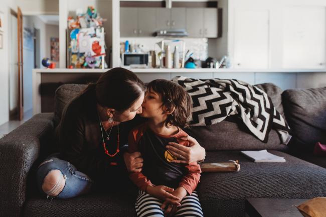 Mother and son kissing on the couch with Family Photographer Perth