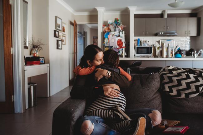 Mother and son hugging on the couch with Family Photographer Perth