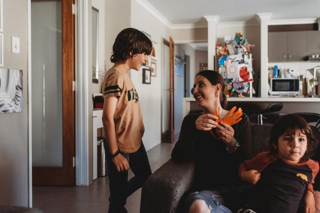 Mother smiling at her son who is standing next to her with Family Photographer Perth