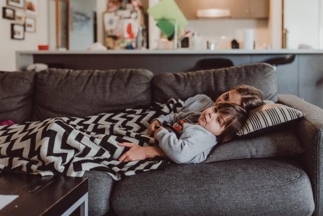 Girl and boy laying on the couch with a blanket with Perth family lifestyle photographer