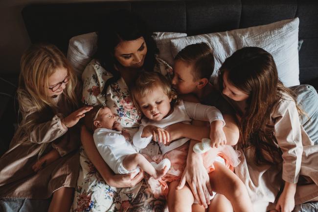 Mother on the bed with her 5 children during a Perth Newborn photography session