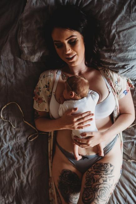 Mother laying on the bed with her new baby on her chest during a Perth Newborn photography session