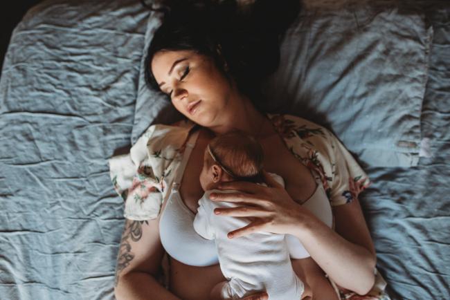 top down image of baby laying on mother's chest during a Newborn lifestyle photographer Perth session