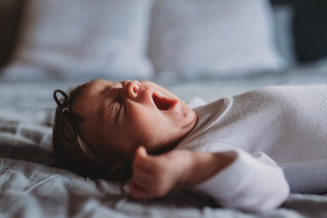 Close up of baby yawning during a Perth Newborn photography session