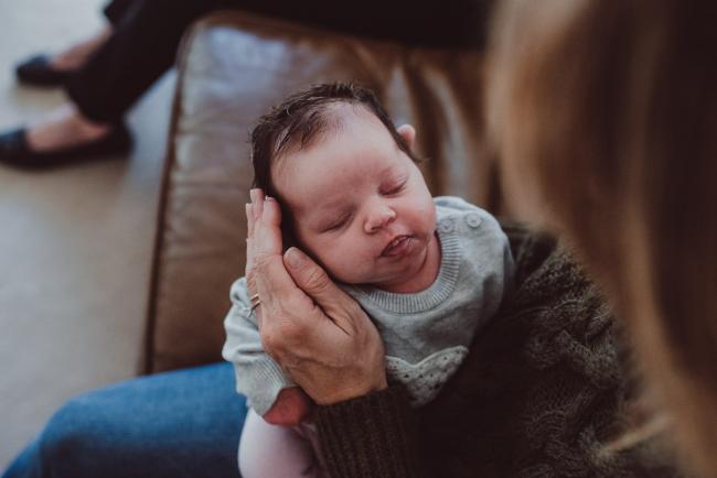 Newborn-Lifestyle-Photographer-Perth-10-of-54 Mothers hand next to her baby's face during a lifestyle newborn photography session in Perth