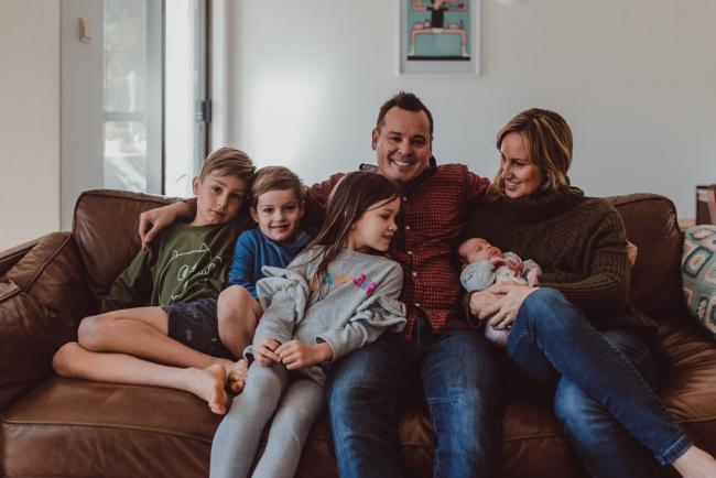 Newborn-Lifestyle-Photographer-Perth-11-of-54 Family of 6 sitting on the couch during a lifestyle newborn photography session in Perth