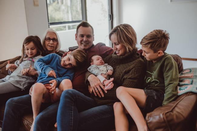 Newborn-Lifestyle-Photographer-Perth-14-of-54 Family sitting on a couch during a lifestyle newborn photography session in Perth