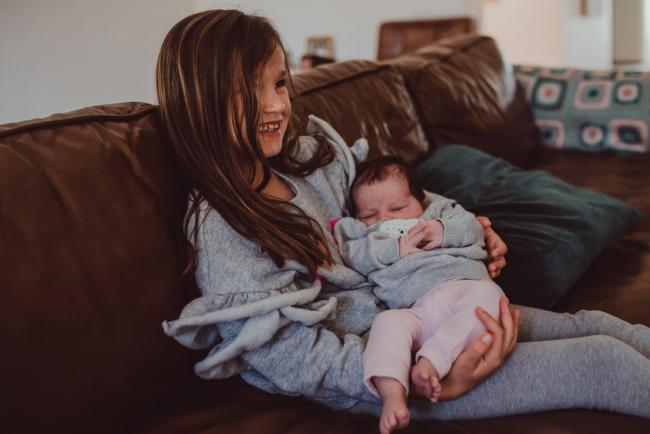 Newborn-Lifestyle-Photographer-Perth-20-of-54 Little girl holding her baby sister during a lifestyle newborn photography session in Perth