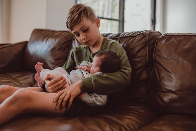 Newborn-Lifestyle-Photographer-Perth-24-of-54 Little boy holding his new baby sister during a lifestyle newborn photography session in Perth
