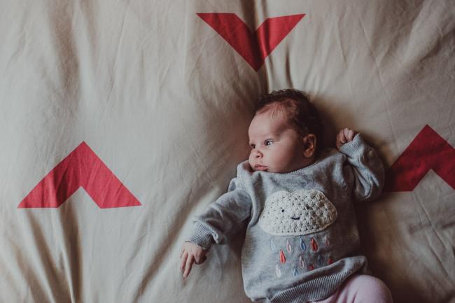 Newborn-Lifestyle-Photographer-Perth-43-of-54 Baby laying on a bed during a lifestyle newborn photography session in Perth