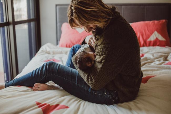 Newborn-Lifestyle-Photographer-Perth-47-of-54 Mother breastfeeding on her bed during a lifestyle newborn photography session in Perth