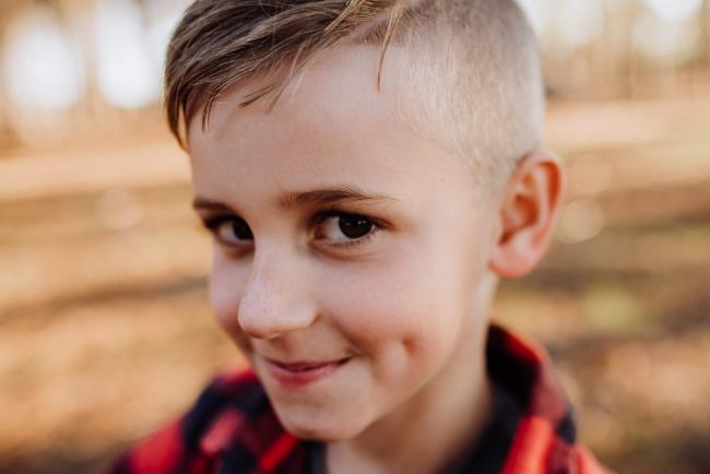 The-Pines-Family-Photographer-Perth-10-of-60 Little boy with dimples looking at the camera during a Perth Family Photography session during Golden Hour at The Pines