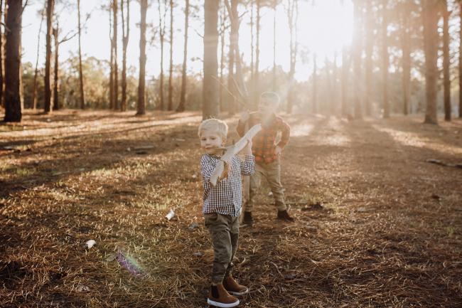 The-Pines-Family-Photographer-Perth-13-of-60 Brothers playing with sticks during a Perth Family Photography session during Golden Hour at The Pines