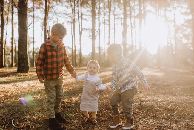 The-Pines-Family-Photographer-Perth-15-of-60 Three siblings holding hands and walking during a Perth Family Photography session during Golden Hour at The Pines