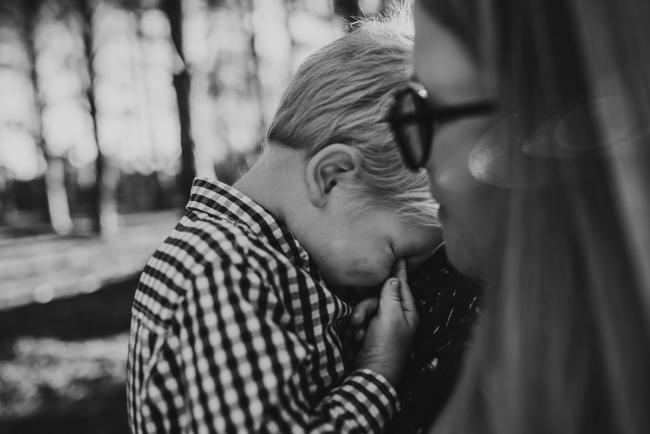 The-Pines-Family-Photographer-Perth-20-of-60 Black and white image of little boy cuddling into his mother during a Perth Family Photography session during Golden Hour at The Pines