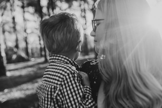 The-Pines-Family-Photographer-Perth-22-of-60 Black and white image of little boy cuddling into his mother during a Perth Family Photography session during Golden Hour at The Pines