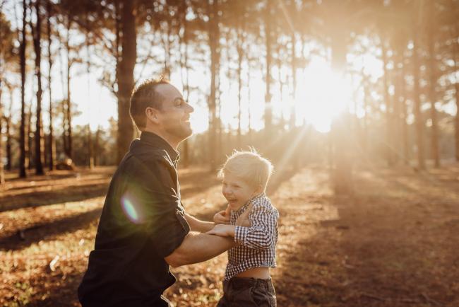 The-Pines-Family-Photographer-Perth-23-of-60 Father lifting his little boy up in the air during a Perth Family Photography session during Golden Hour at The Pines