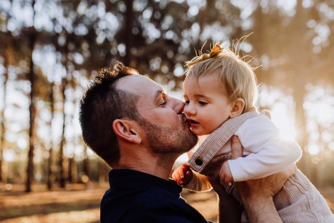 The-Pines-Family-Photographer-Perth-26-of-60 Father kissing his daughter during a Perth Family Photography session during Golden Hour at The Pines