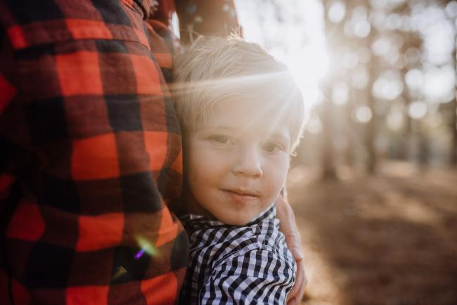 The-Pines-Family-Photographer-Perth-4-of-60 Little boy cuddling into his brother during a Perth Family Photography session during Golden Hour at The Pines