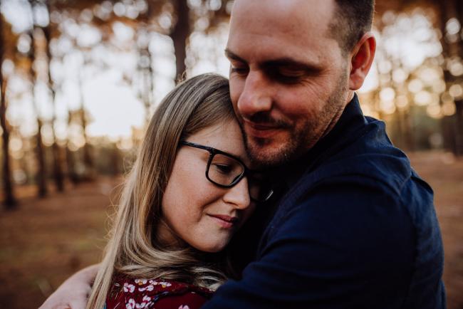 The-Pines-Family-Photographer-Perth-44-of-60 Wife cuddling into her husband during a Perth Family Photography session during Golden Hour at The Pines