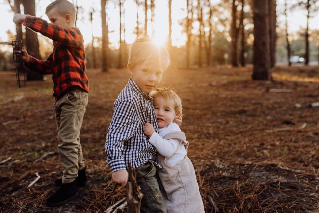 The-Pines-Family-Photographer-Perth-45-of-60 Little sister holding onto her big brother during a Perth Family Photography session during Golden Hour at The Pines