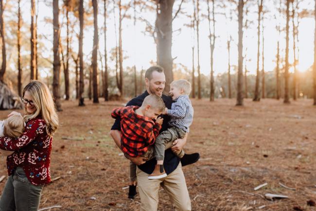 The-Pines-Family-Photographer-Perth-46-of-60 Father holding his boys and mother holding her daughter during a Perth Family Photography session during Golden Hour at The Pines