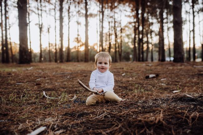The-Pines-Family-Photographer-Perth-48-of-60 Little girl holding a stick during a Perth Family Photography session during Golden Hour at The Pines