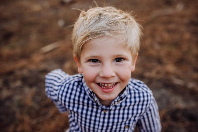 The-Pines-Family-Photographer-Perth-50-of-60 Little boy smiling at the camera during a Perth Family Photography session during Golden Hour at The Pines