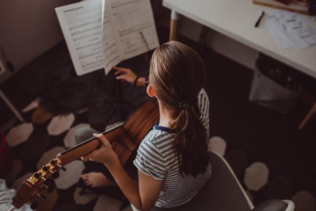 20190622-DSC_8090 Top down image of girl changing sheet music as she plays guitar with Perth family lifestyle photographer