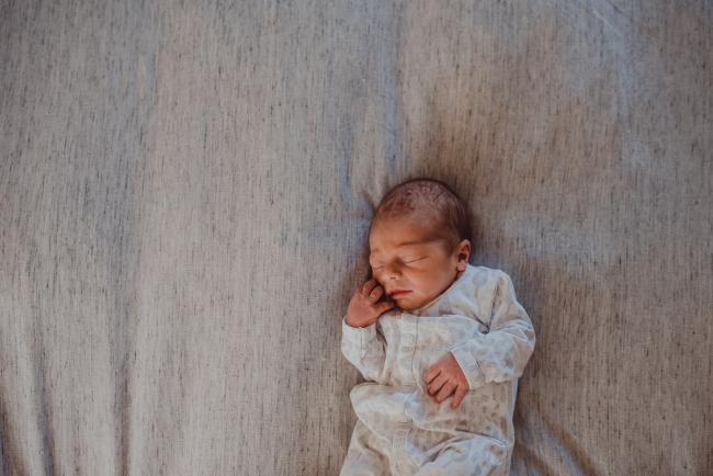 Top down image of new baby on a bed during a Perth Fresh 48 photography session captured in home